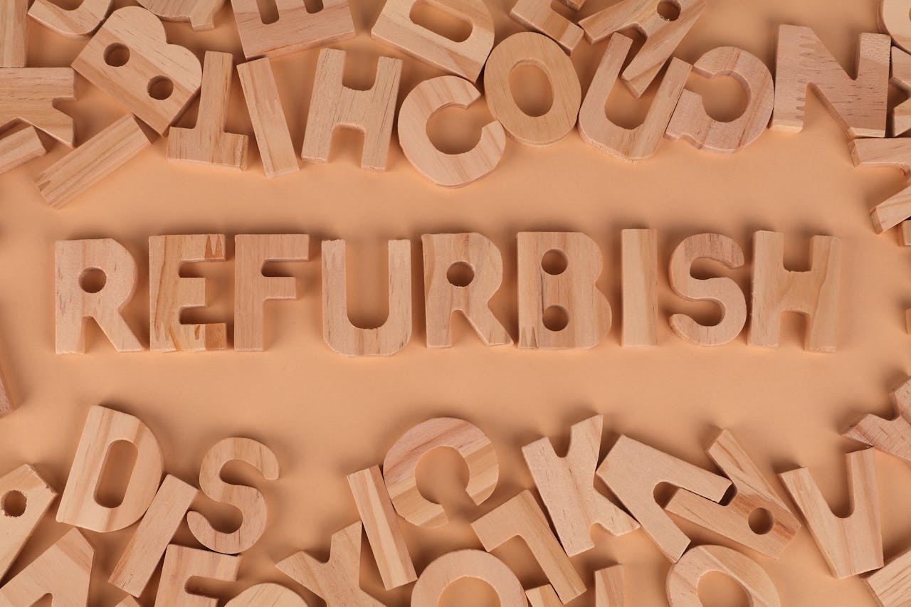 heros-img Creative arrangement of wooden letters spelling Refurbish on a warm brown surface, ideal for concepts related to reuse and sustainability.